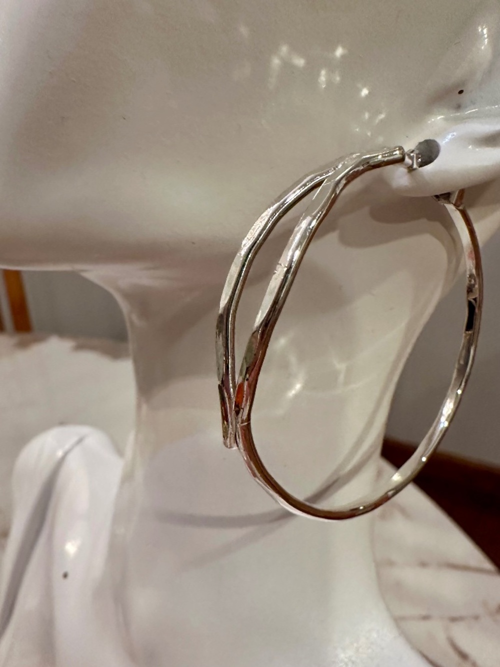 Robert Lee Morris Silver hoop earrings with a unique twisted design, size large